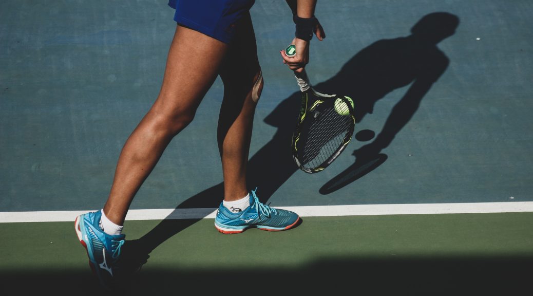 Woman playing tennis- serving